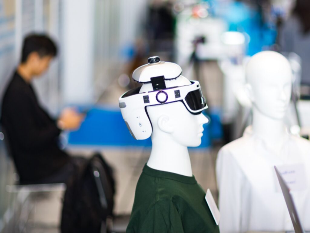 خوذة واقع معزز (AR) متطورة مثبتة على رأس نموذج أزرق تعكس أحدث تكنولوجيا العرض البصري.