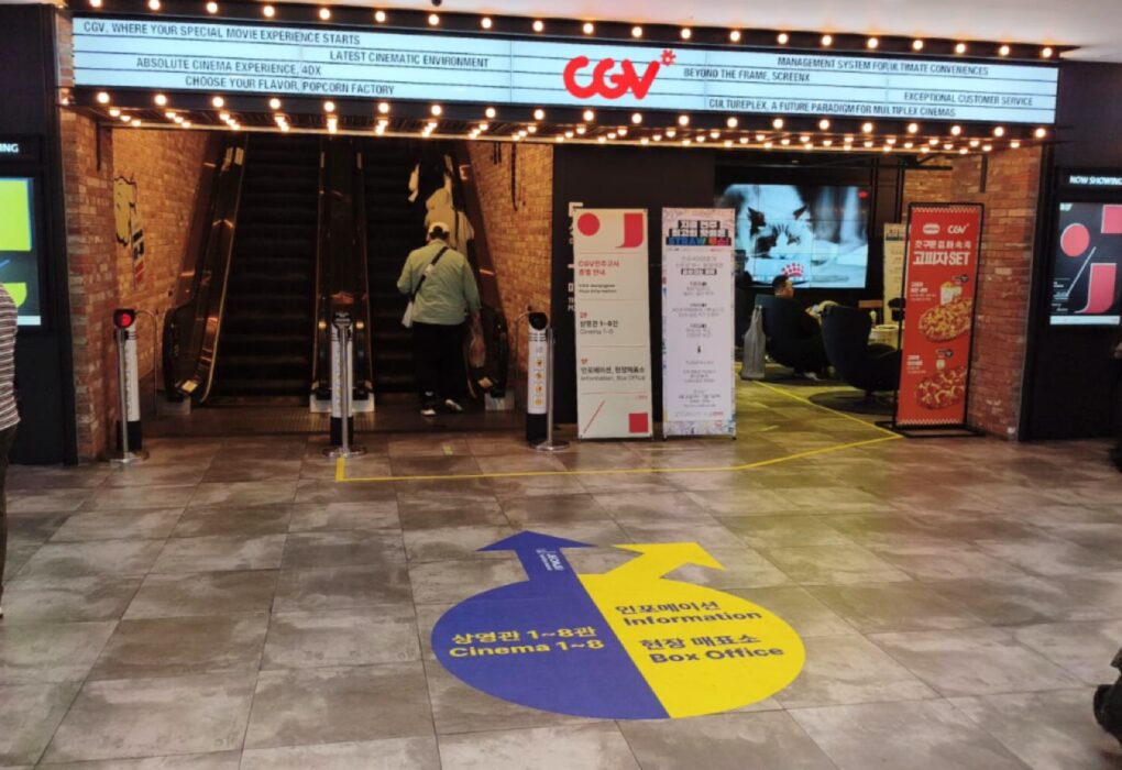 لقطة لمدخل سينما CGV بمدينة جونجو تظهر اللوحات الإرشادية الأرضية والملصقات الترويجية لزوار مهرجان جونجو السينمائي الدولي. عدسة بلاك كات 24.